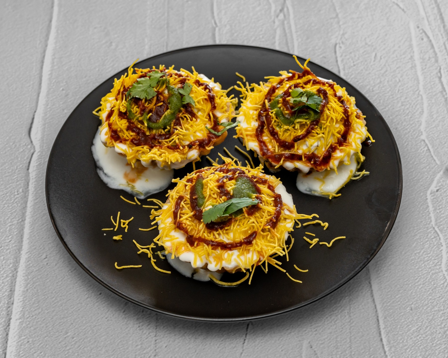 Our popular Basket Chaat with yogurt, chutneys and sev